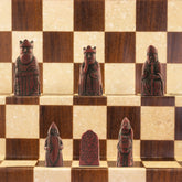 A miniature chess set inspired by the Isle of Lewis chessmen, the oldest known chess set.
In 1831 the sea carried away a sandbank on the Isle of Lewis uncovering a mysterious building that had been buried under the sand. A peasant working nearby found what he concluded to be a collection of Elves and Gnomes. The superstitious highlander flung down his spade and fled home in horror.